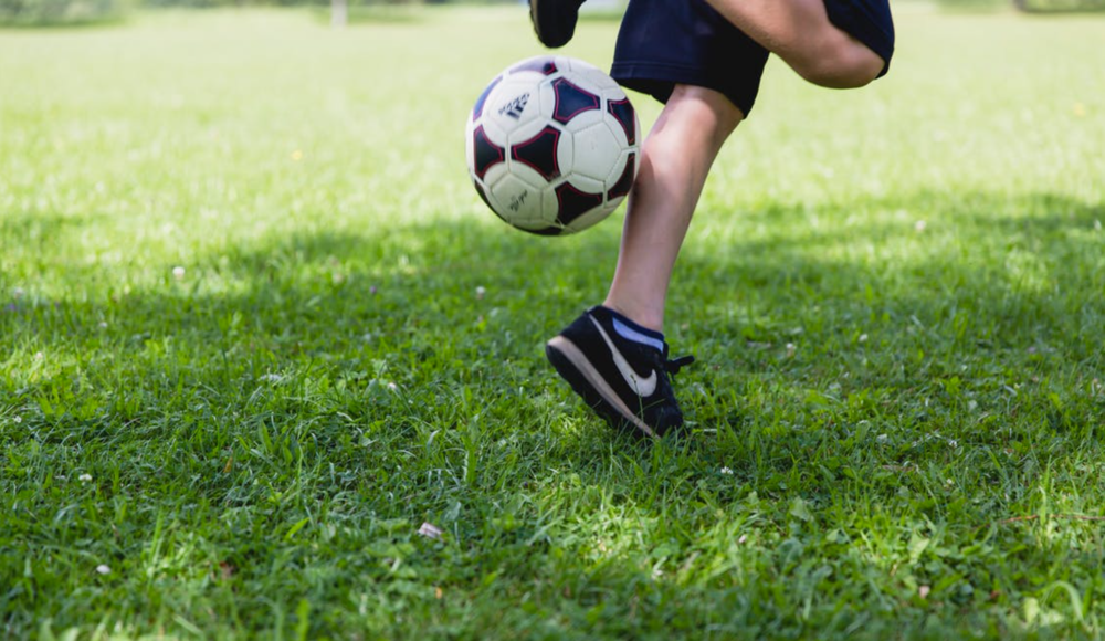 A child running in a soccer field